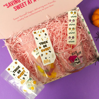 Halloween-themed gift box filled with vegan sweets, including marshmallows, gummies, and a ghost-themed cup, perfect for gifting to friends and family during Halloween